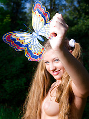Perfect long haired busty teen cutie taking off her clothes and catching a big butterfly.