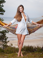 Elizabeth youthful yet alluring beauty stands out all over the grassy cliff overviewing the ocean as she sensually strips her light blue polo and poses elegantly on the hammock.