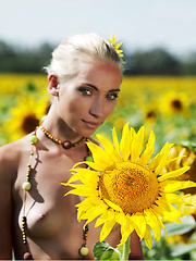 Amidst a large field of sunflowers in full bloom, Adele's natural beauty is the fairest of them all as she confidently poses her gorgeous body with perfectly erect nipples under the warm sun.