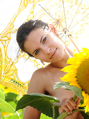 Suzanna A\'s carefree allure and charming beauty stands out amidst a field of sunflowers