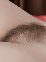 Amelia strips naked before modeling naked in bed